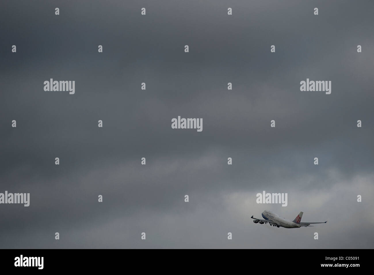 Airplane flying into storm at Schiphol Airport Amsterdam Stock Photo ...