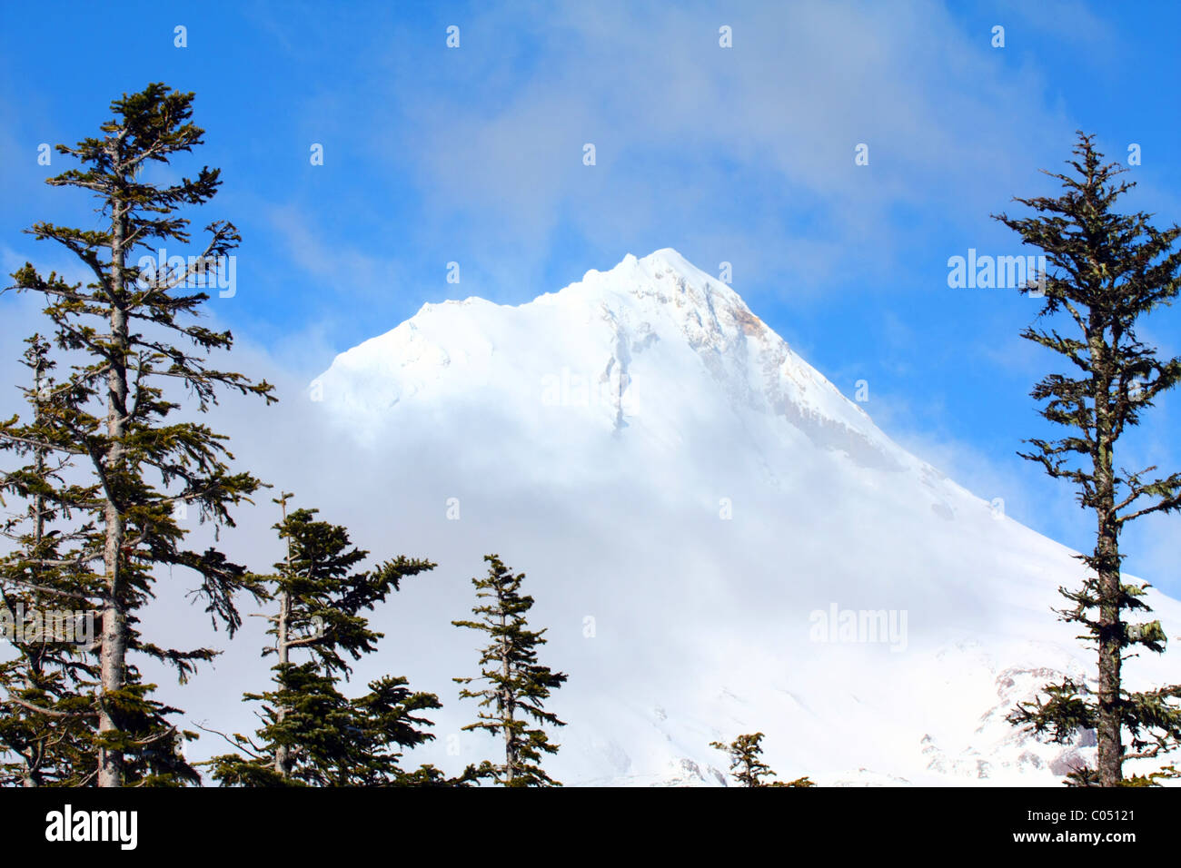 Mt Hood in Oregon, with its snow covered steep mountain peak with thin