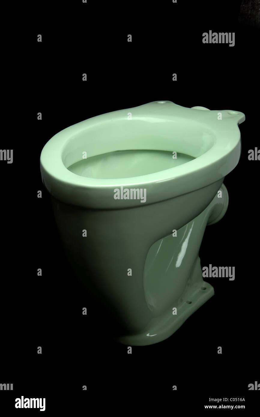 The light green toilet bowl, isolated on black background Stock Photo