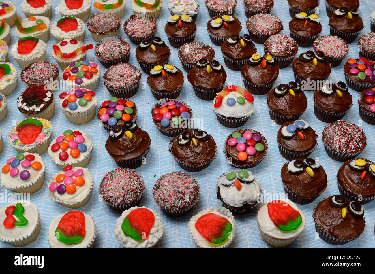 Decorated home made cupcakes on a table for a large party Stock Photo