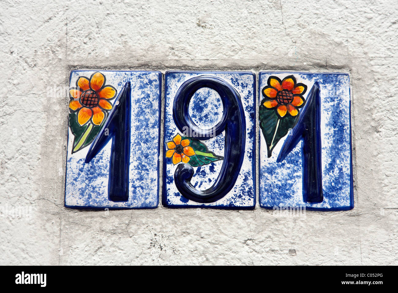 beautiful whimsical decorative glazed ceramic house number hand painted with marvelous colored floral design  Roma district Stock Photo