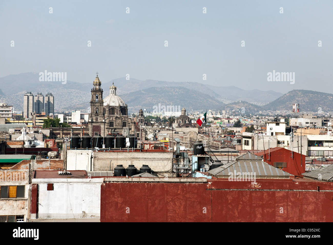 intimate view across colorful variegated rooftops of Mexico City on a clear day to beauty of surrounding mountains Mexico Stock Photo