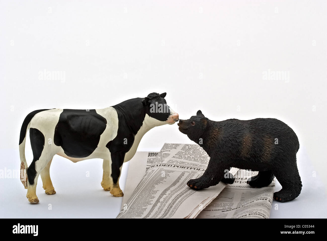 Bear standing face to face with a bullupon a stock market listing. Stock Photo
