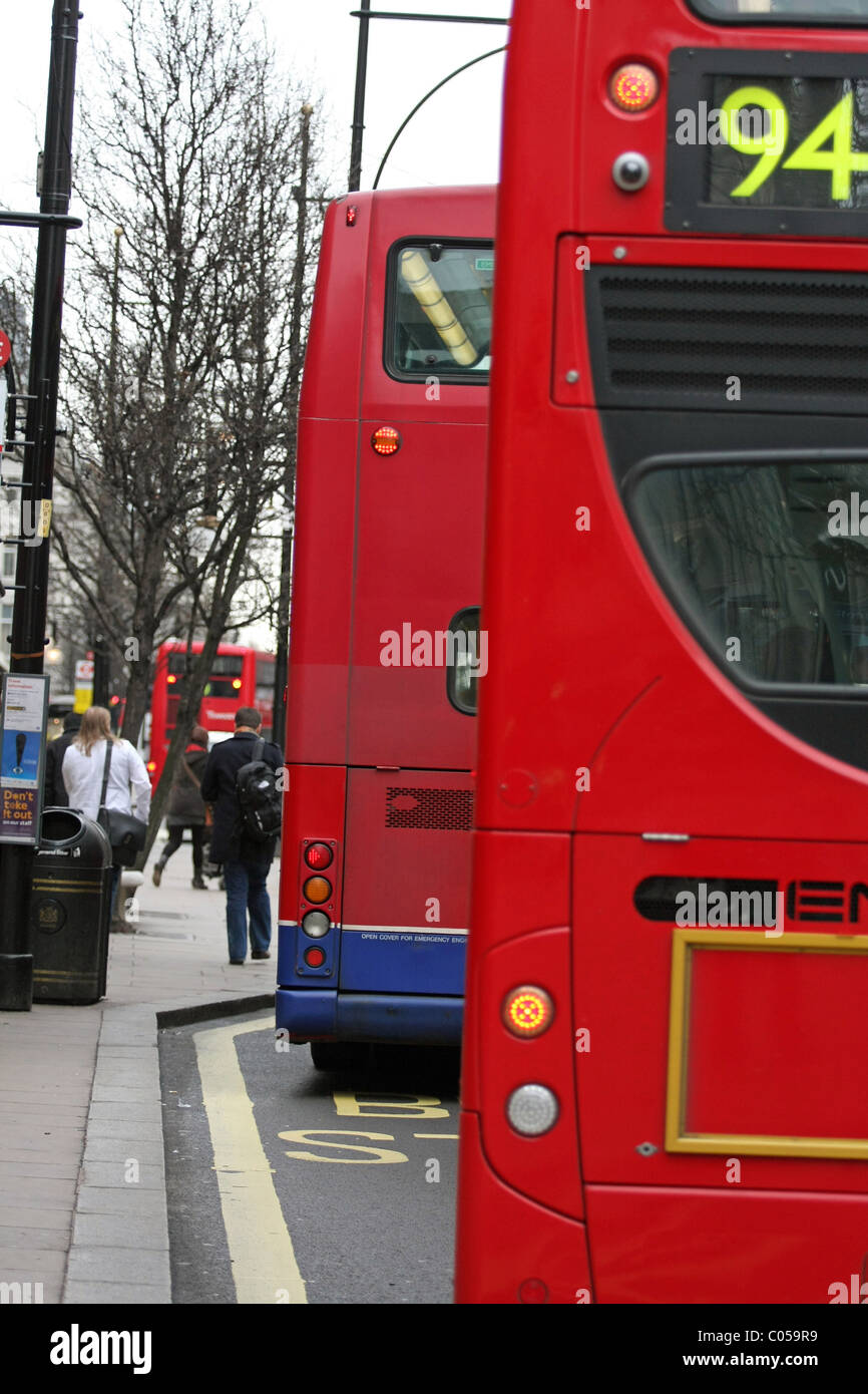 Two buses leaving a bus stop in Oxford Street, London Stock Photo
