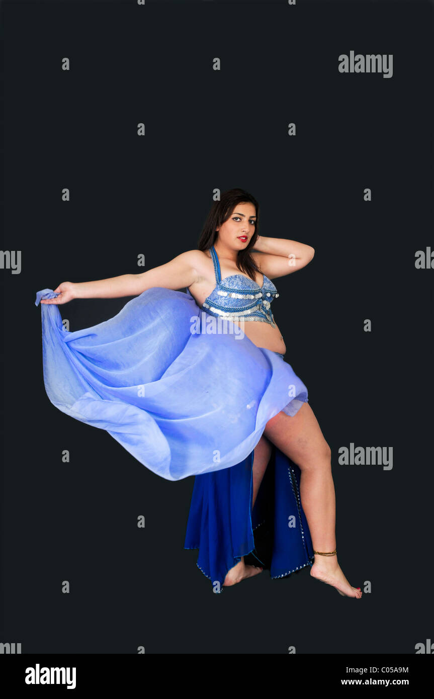 Belly dancer in blue On black Background Stock Photo