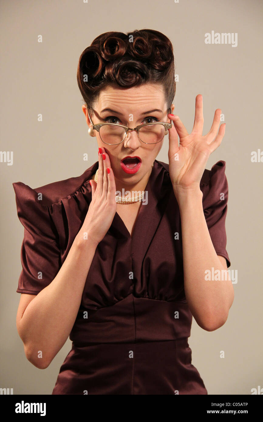 Old fashioned woman looking shocked Stock Photo