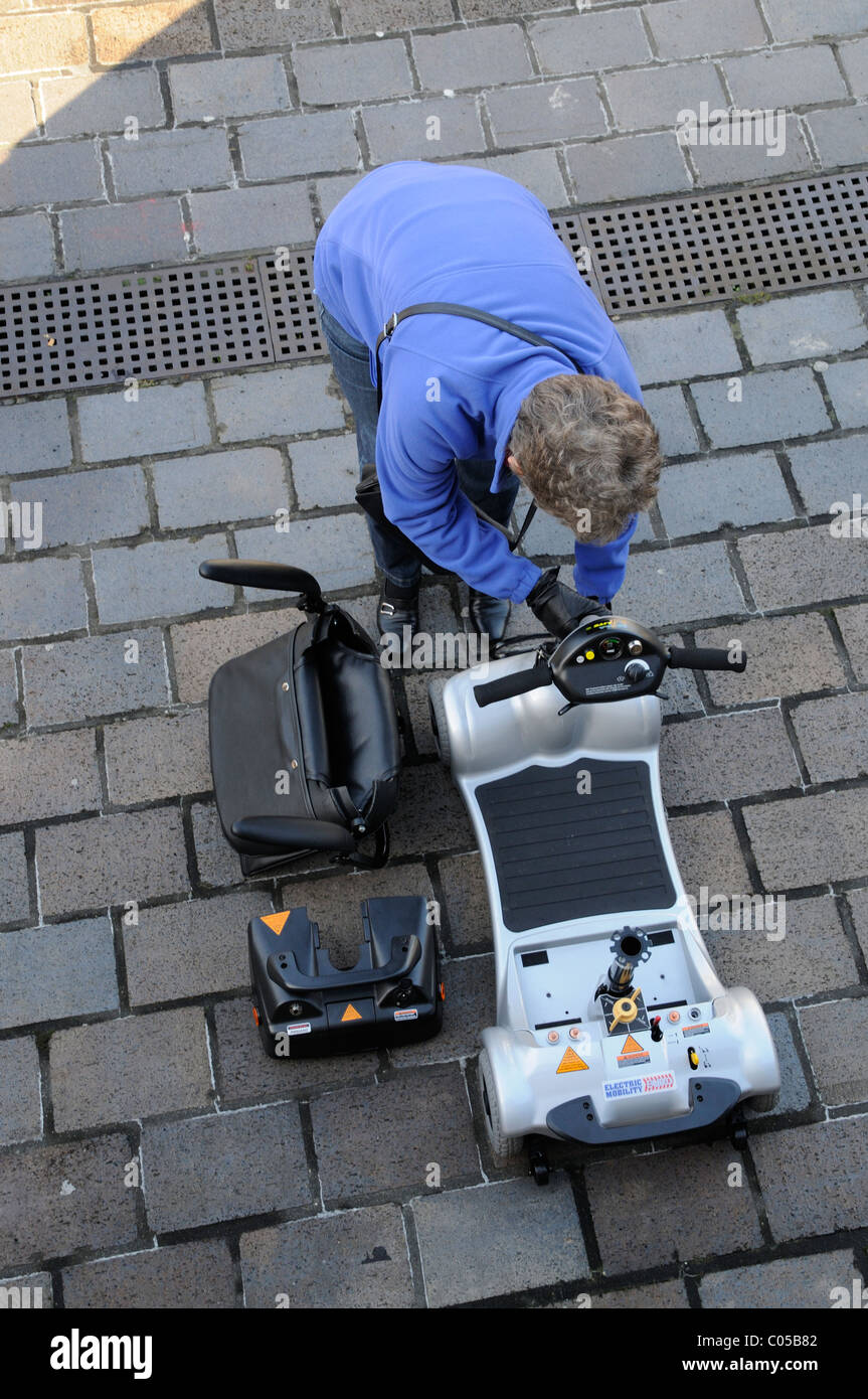 Mobility scooter user assembling an ultra light battery powered machine