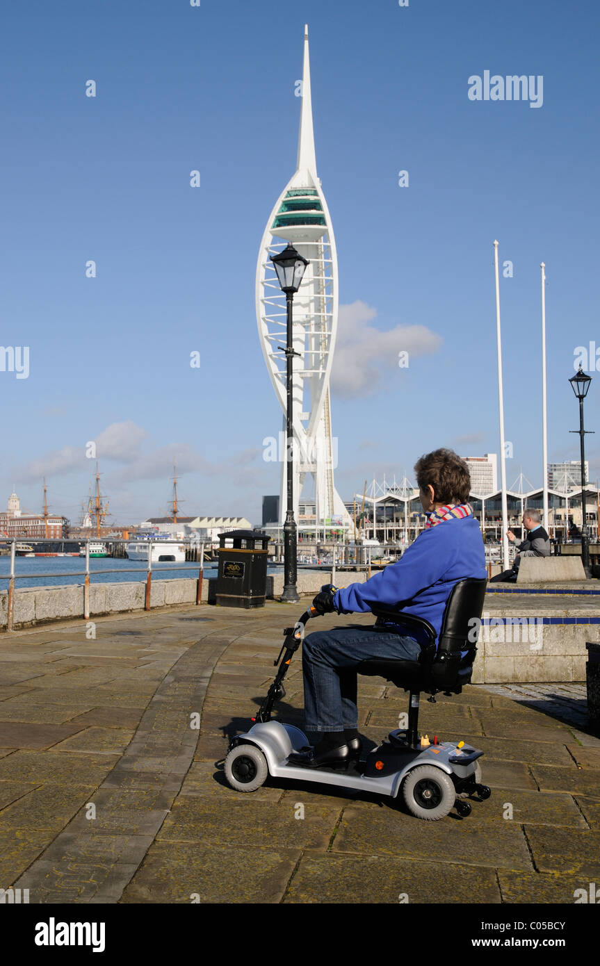 Mobility scooter user riding a three wheel battery powered machine in