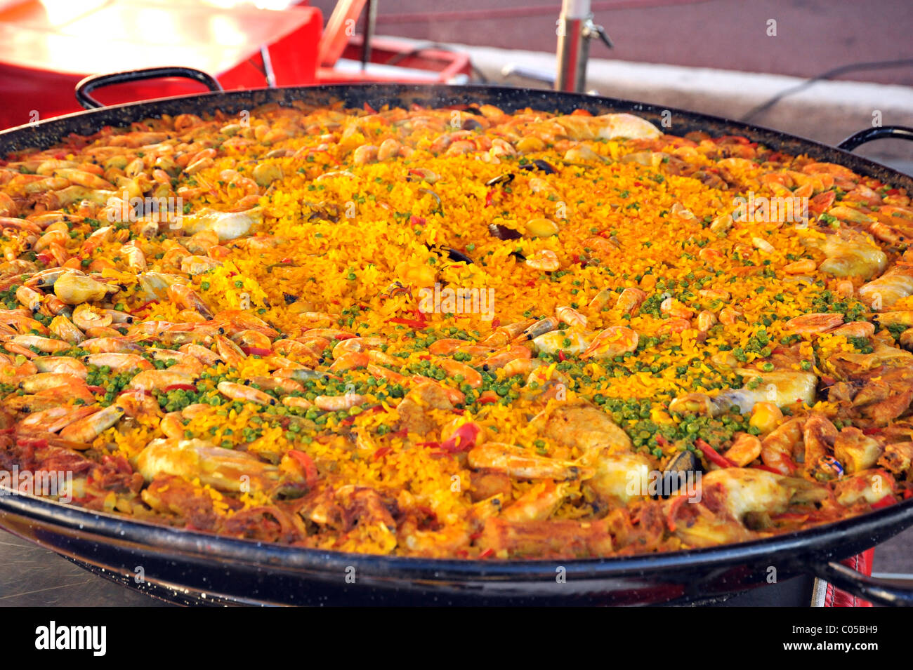 Paella being cooked outside in a huge pan Street market in France