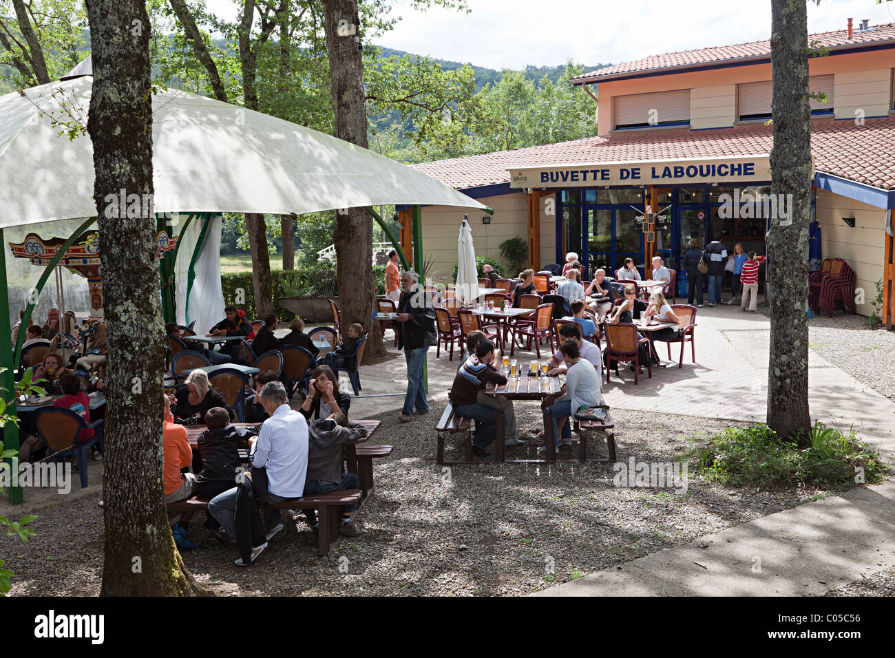 Outdoor cafe buvette with people waiting for tour Riviere Souterraine