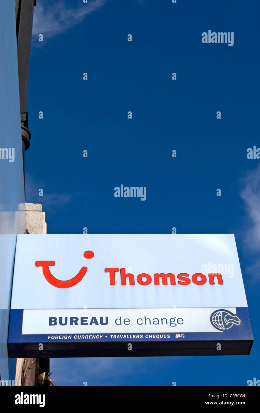 sign for a branch of the british travel agent thomson, with bureau de change, in new malden, surrey, england Stock Photo