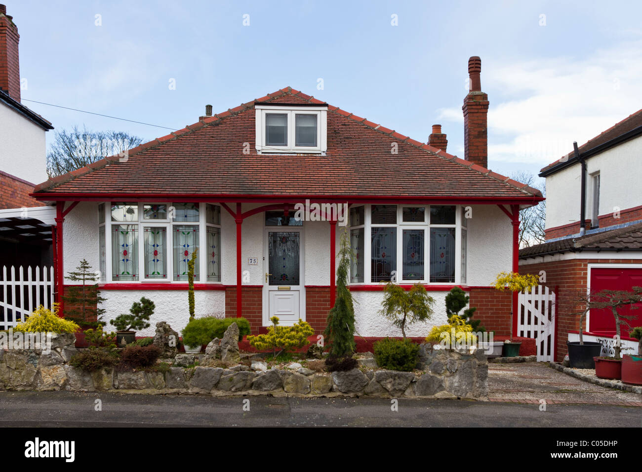 Well-maintained 1920s bungalow of brick with tiled roof and dormer window Stock Photo