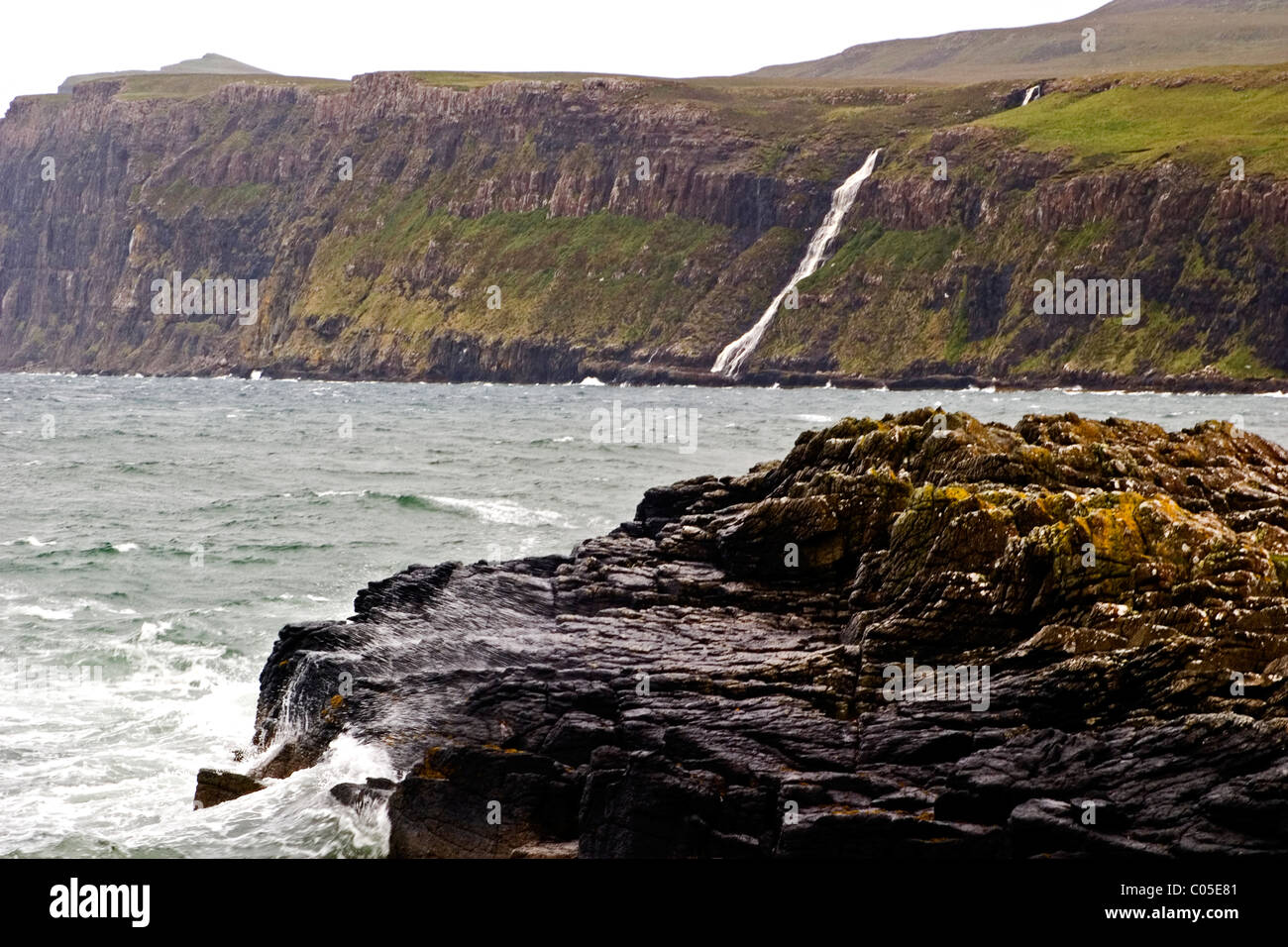 Waterfall into to ocean near Neist point on the Isle of Skye Stock Photo