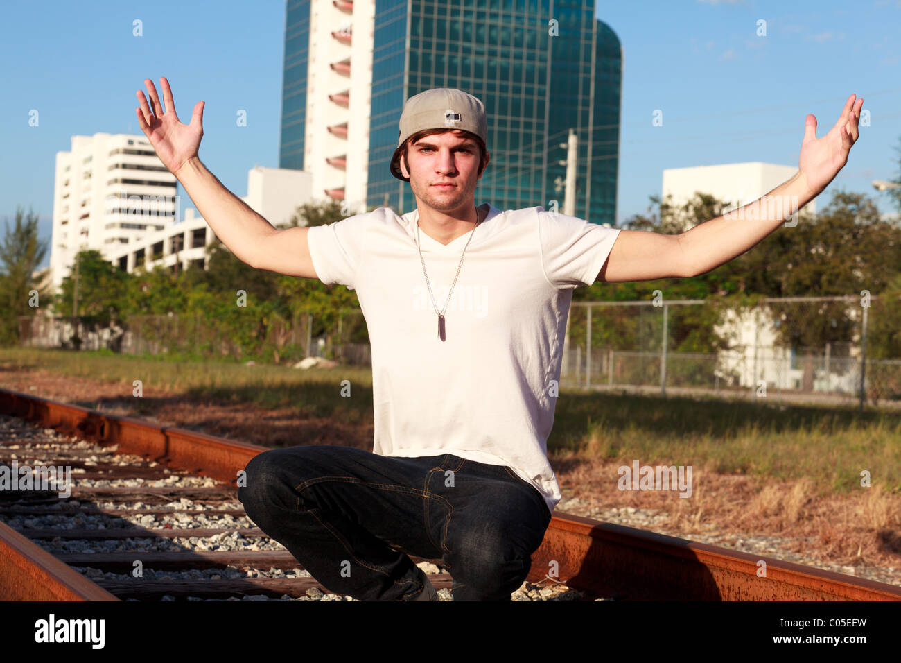 Kneeling young man outdoors hi-res stock photography and images - Alamy
