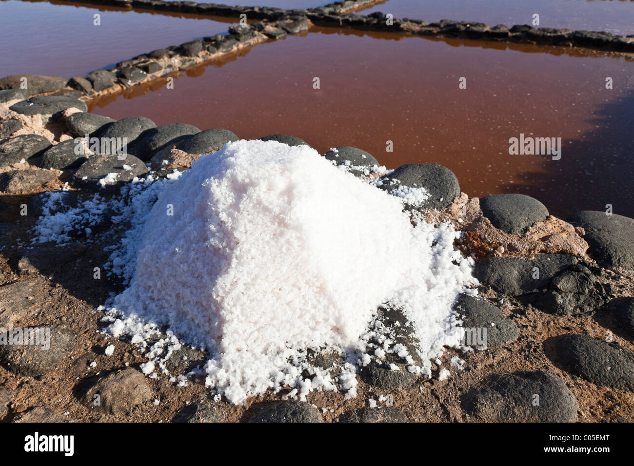 A pile of sun dried salt beside the evaporation pans at the Fuerteventura Salt Museum on the Canary Island of Fuerteventura Stock Photo