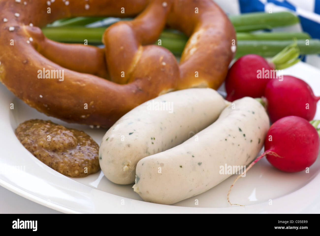 Weisswurst with Pretzel and sweet mustard  as closeup on a white plate Stock Photo