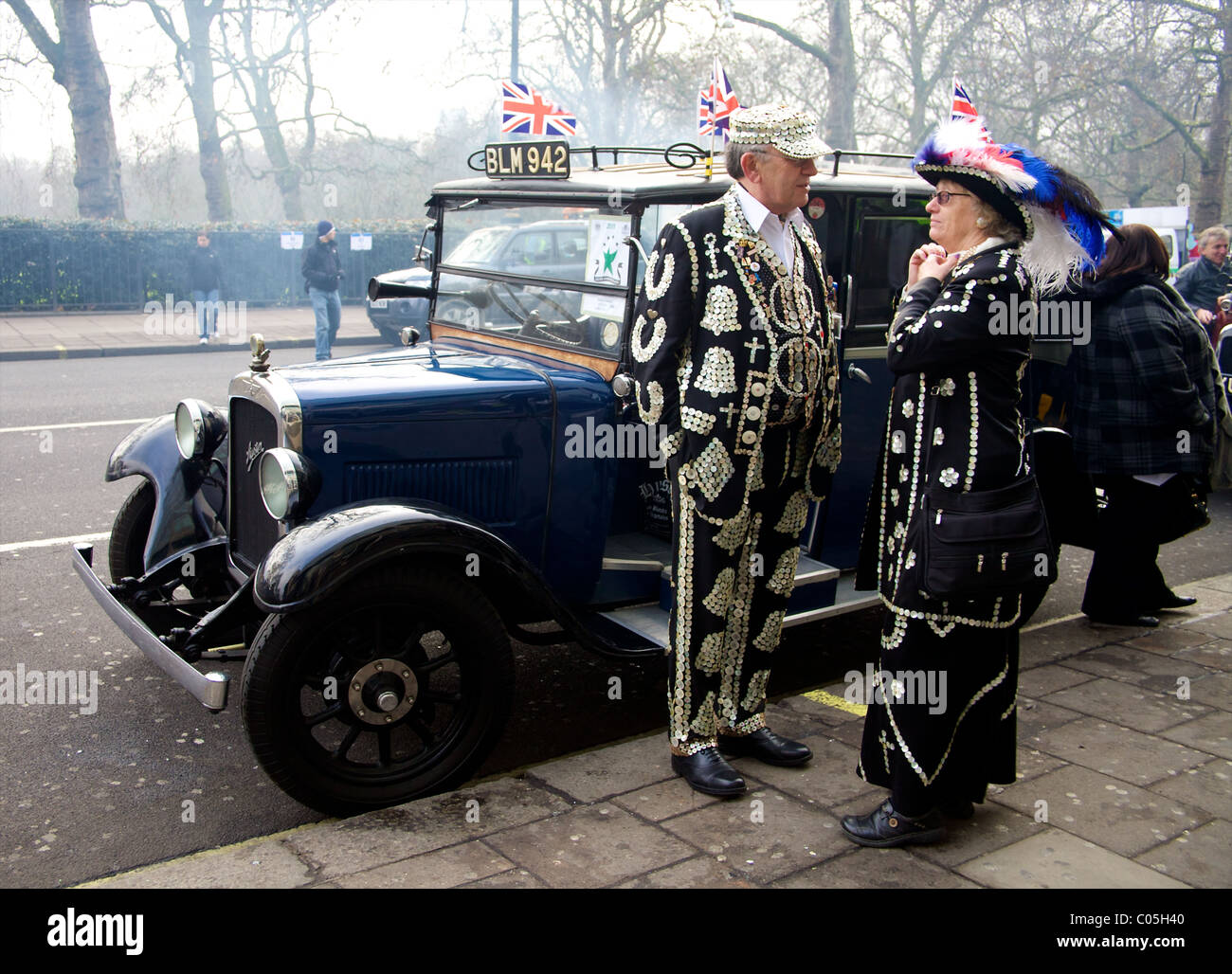 Pearly King and Queen standing next to a classic car at the New Years Day Parade London 2011 Stock Photo