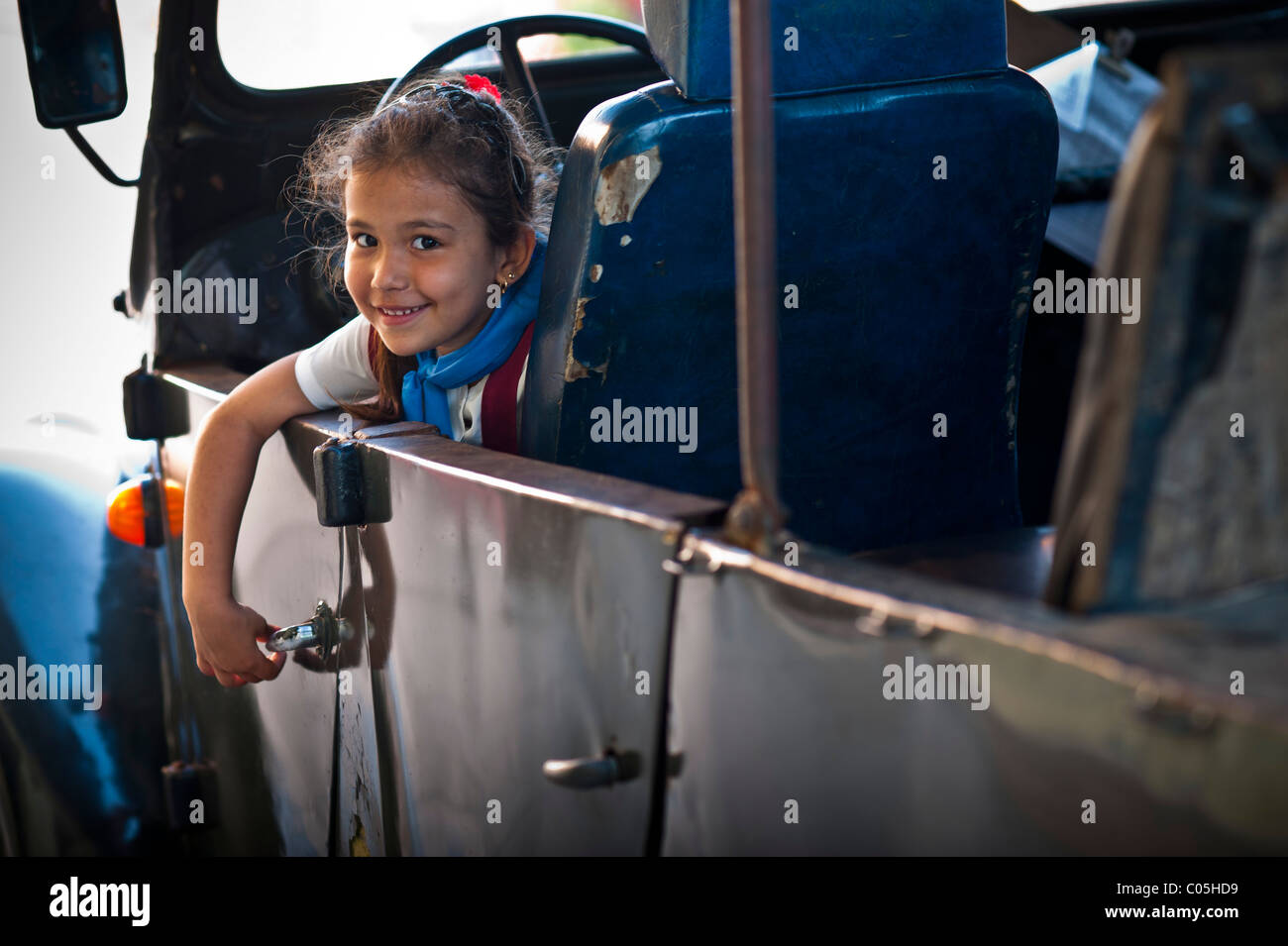 School Girl in classic 1950s American car Trinidad UNESCO World Heritage Site Cuba West Indies Caribbean Central Stock Photo