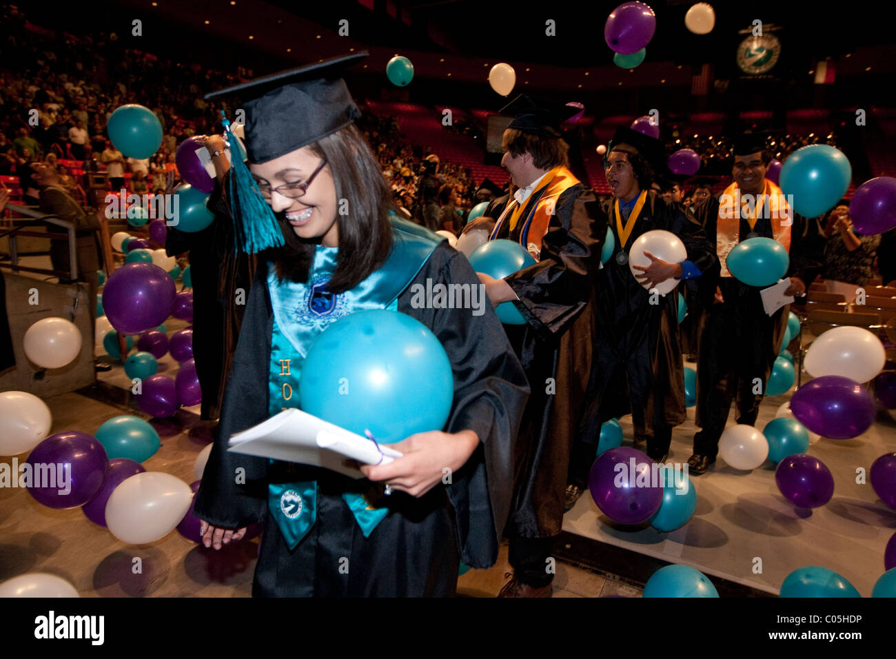 Balloons fall from ceiling to celebrate end of graduation ceremony for Mission Early College High School graduates in El Paso TX Stock Photo
