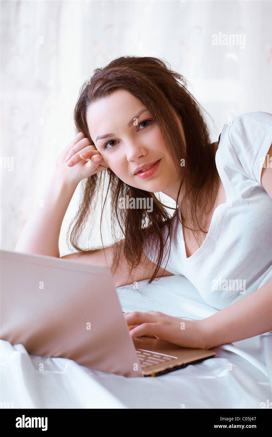 relaxing girl with laptop Stock Photo - Alamy