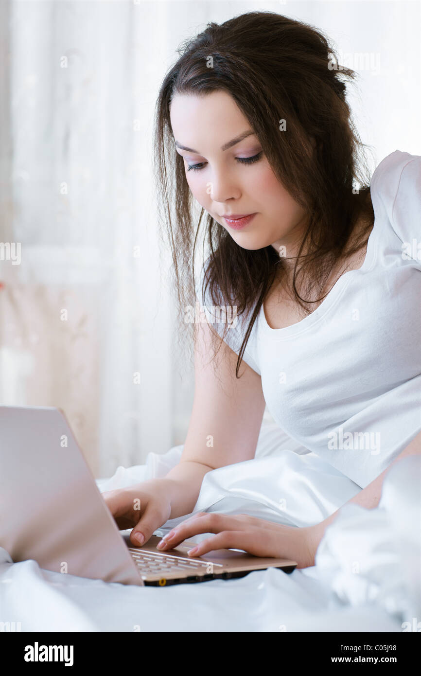 relaxing girl with laptop Stock Photo - Alamy