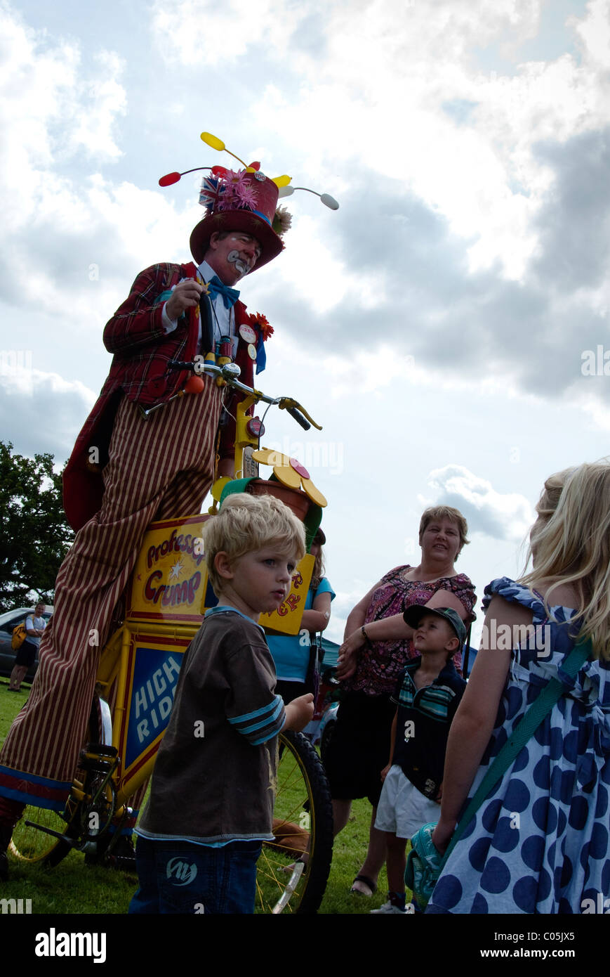 Clown on stilts with children onlookers at Brailes village show