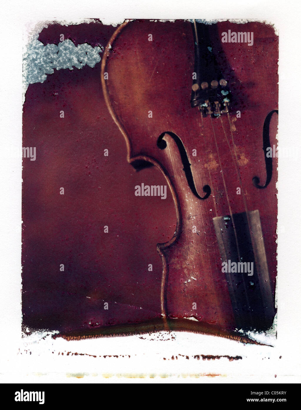 a polaroid emulsion transfer of an old violin Stock Photo