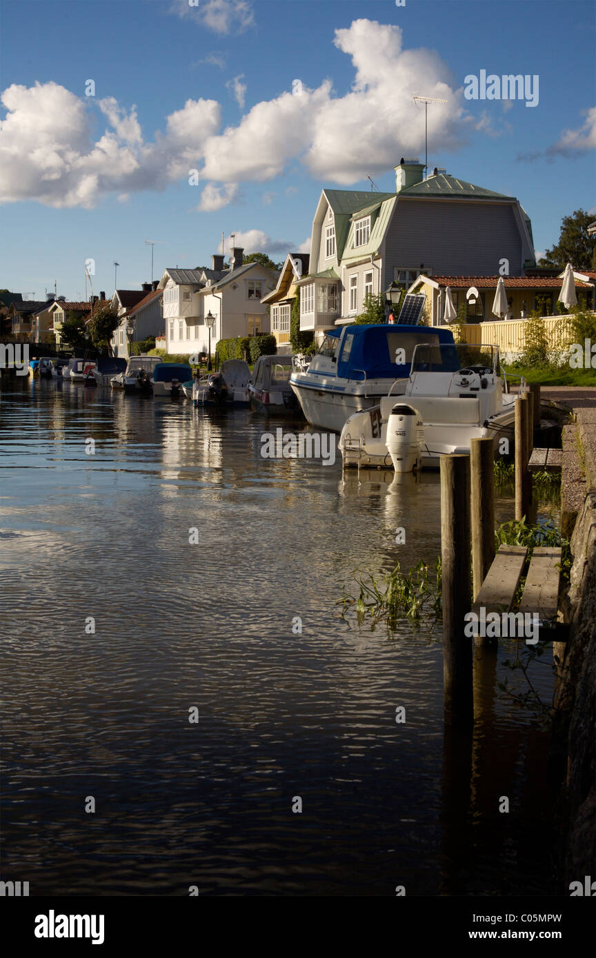 canalside houses and moored boats in Trosa, Sweden Stock Photo