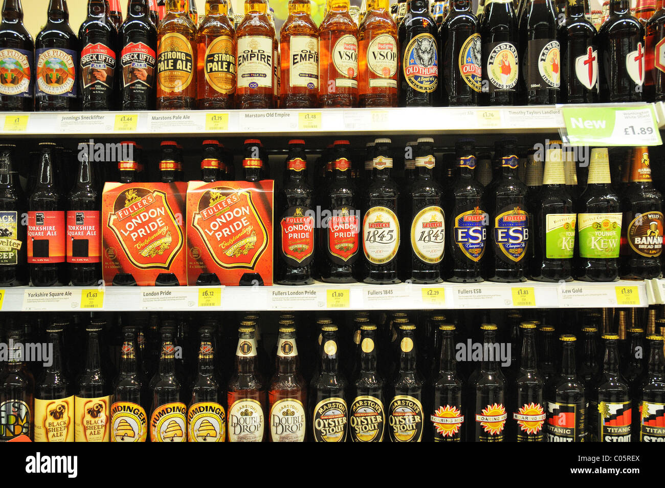 Bottled beers on a shelf in a supermarket in England Stock Photo