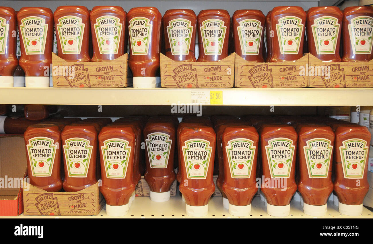 Bottles of Heinz tomato ketchup on a shelf in a supermarket in England Stock Photo