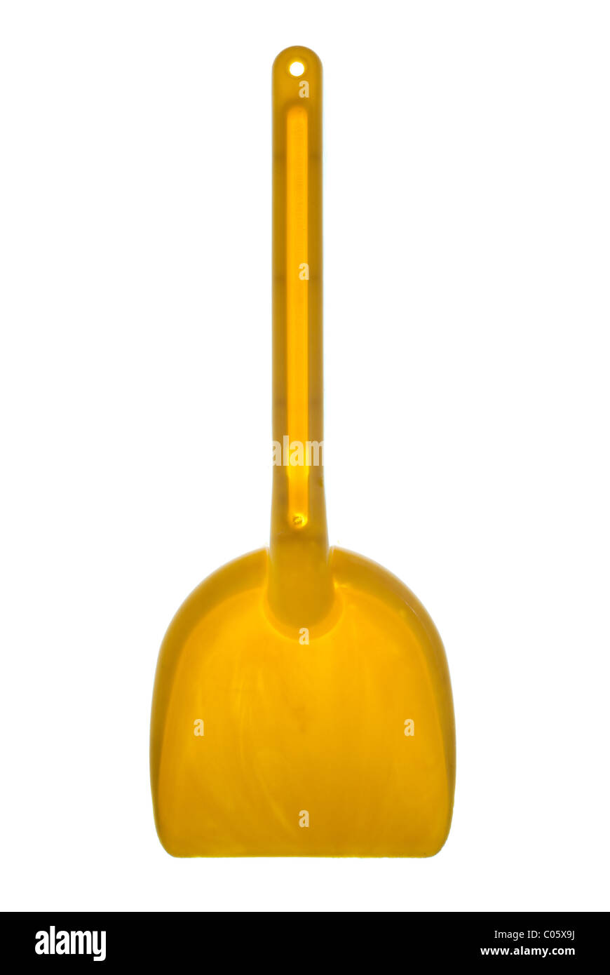 Yellow toy shovel isolated on a white background Stock Photo - Alamy
