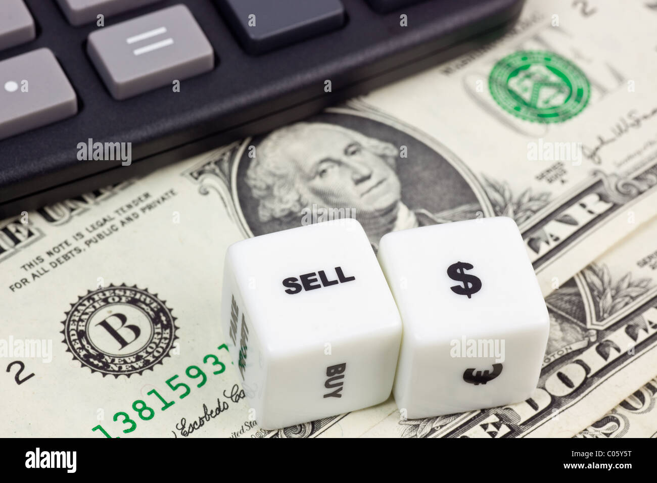 US currency with calculator and dice Stock Photo