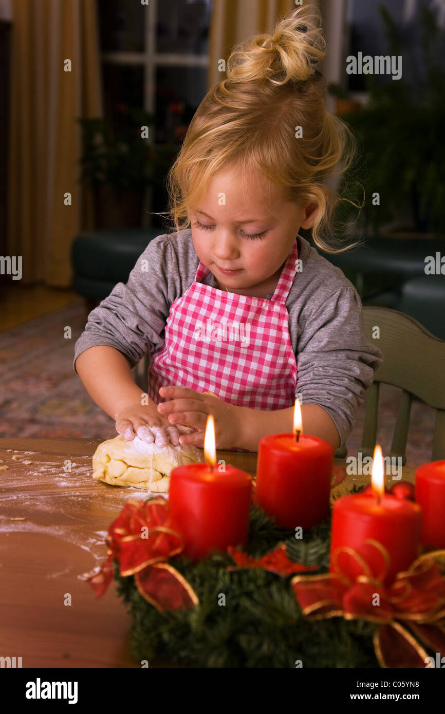 Child to bake Christmas cookies during Advent Stock Photo