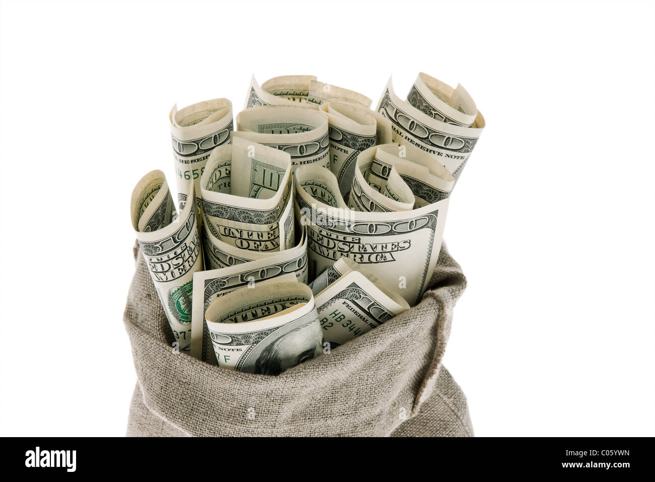 Dollar money bills into a bag Stock Photo