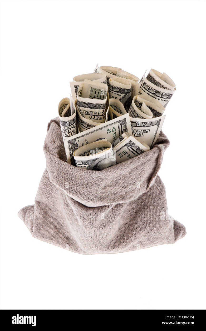 Dollar money bills into a bag Stock Photo