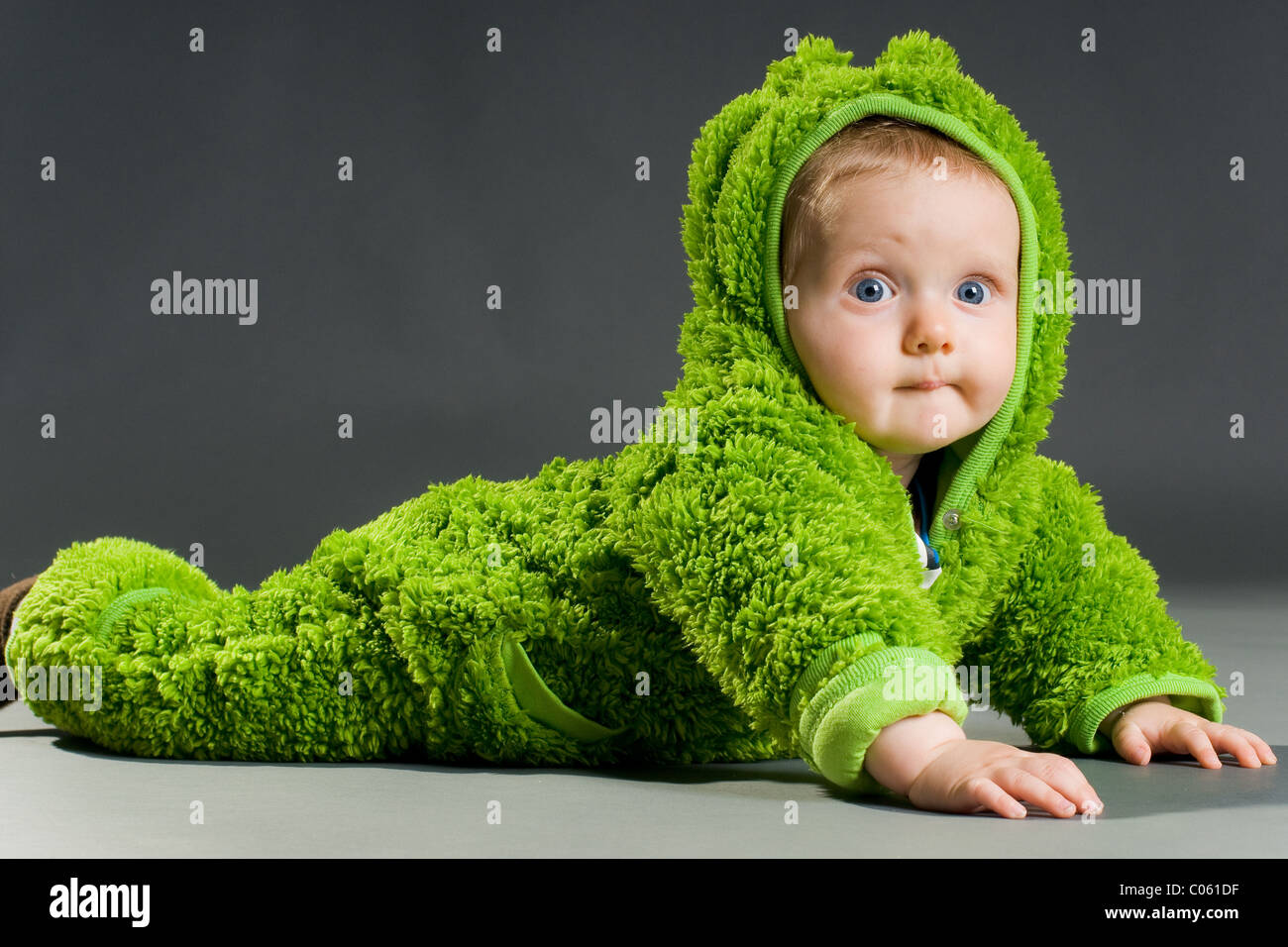Baby wearing a frog costume Stock Photo