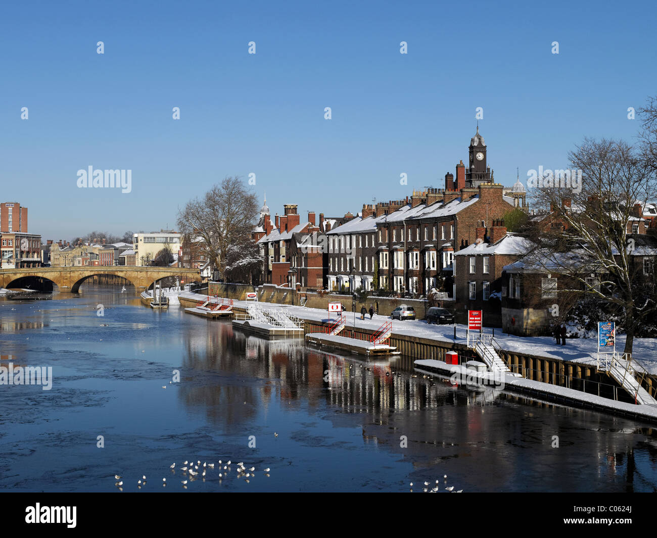 Snow on city town houses buildings on South Esplanade and river Ouse