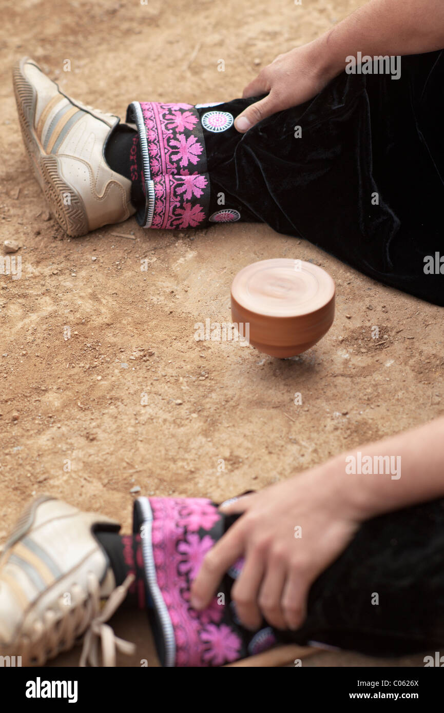Traditional spinning top (Tujlub) competition action at a Hmong new