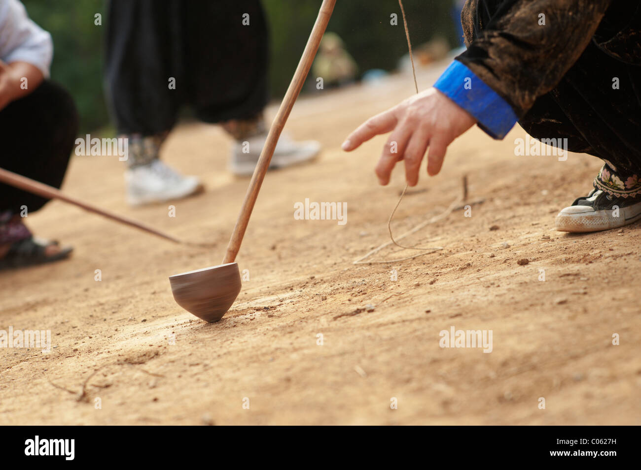 Traditional spinning top (Tujlub) competition action at a Hmong new