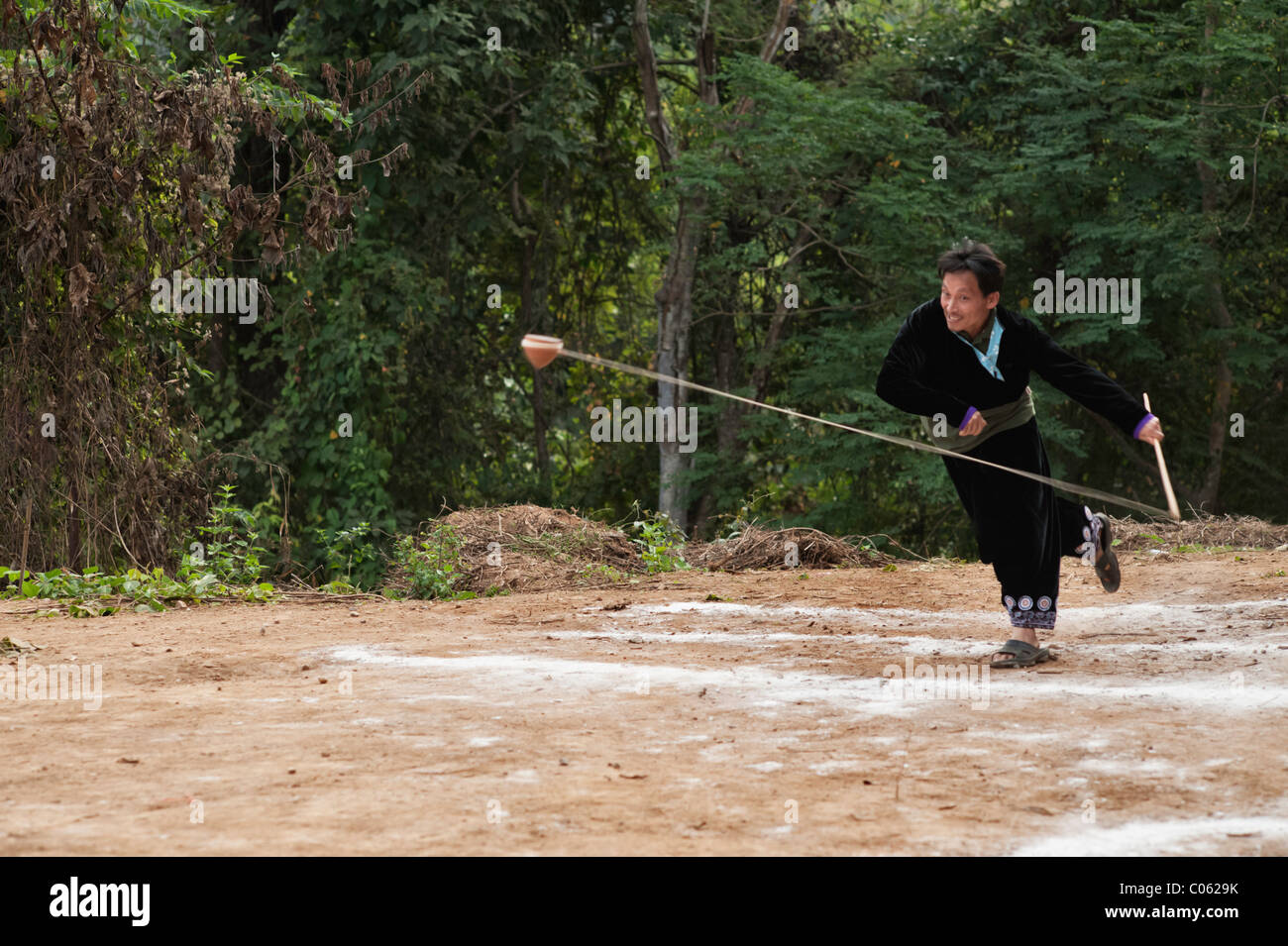 Traditional spinning top (Tujlub) competition action at a Hmong new