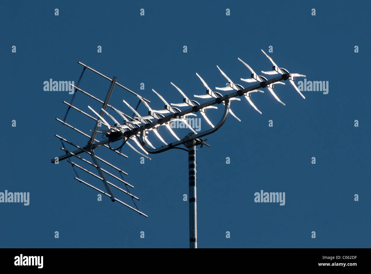 A television aerial or antenna against a plain blue sky.  A good aerial is required for the UK digital switchover. Stock Photo