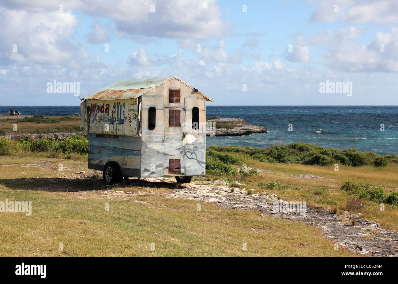 Snack van on the Indian Town Point National Park with Devil's Bridge and Caribbean Ocean in the Distance, Antigua, West Indies. Stock Photo