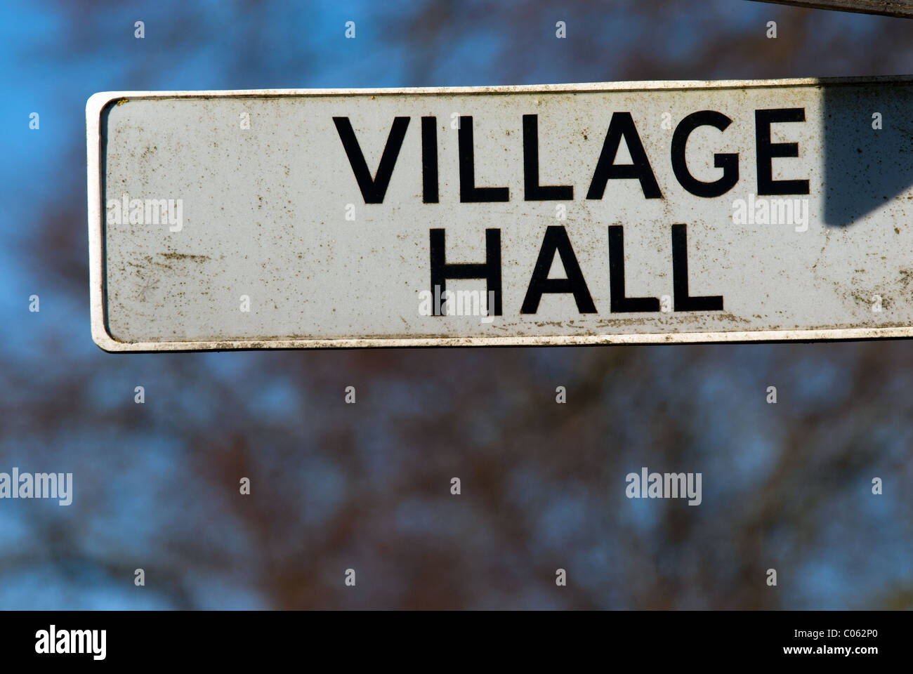 A sign pointing to a British village's Village Hall.  Village Halls are often the centre of the social life of a village. Stock Photo