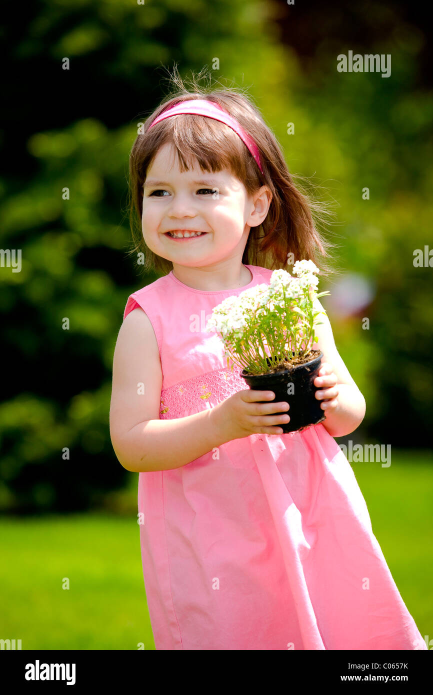 Little girl with flower pot Stock Photo - Alamy