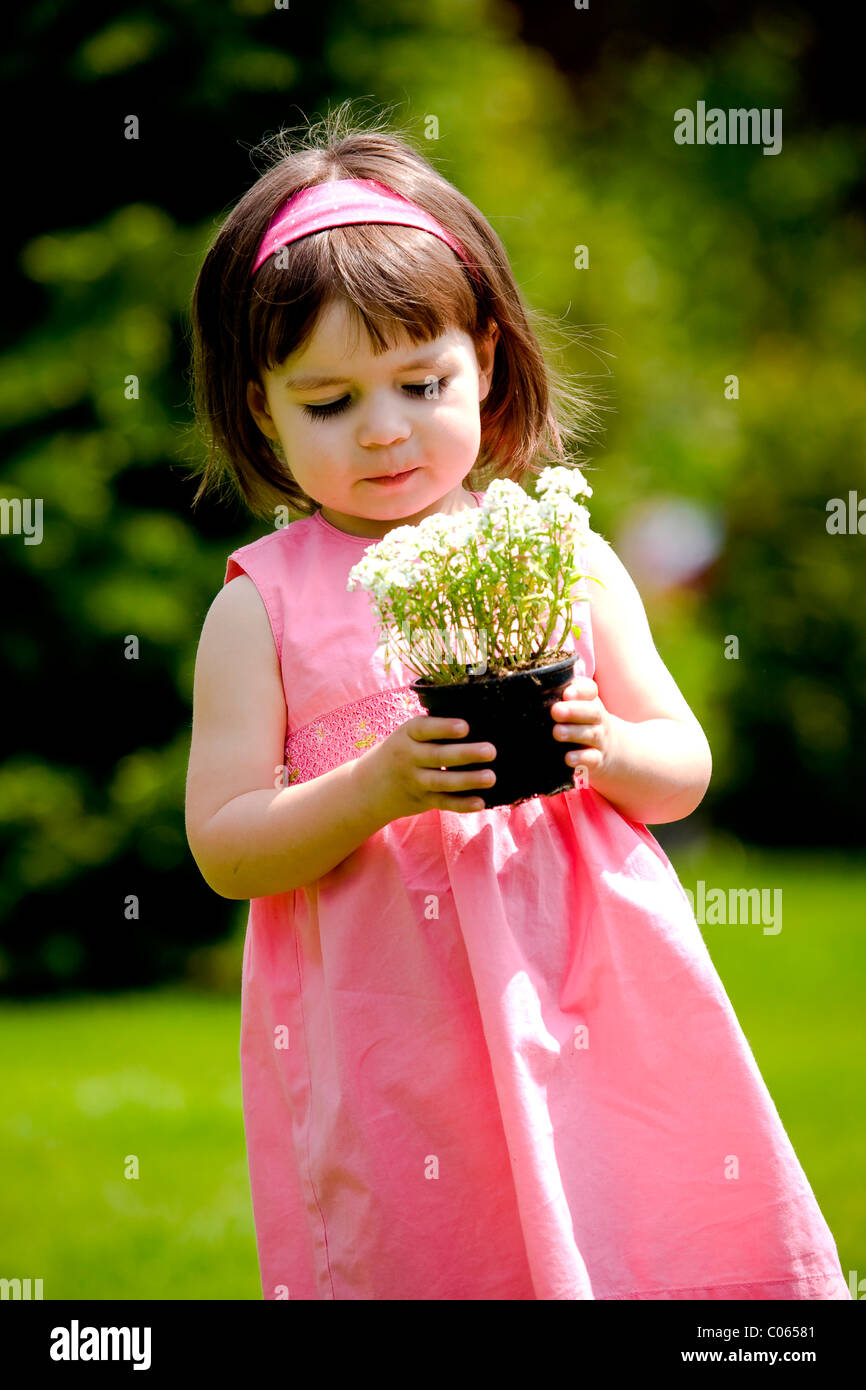 Little girl with flower pot Stock Photo - Alamy