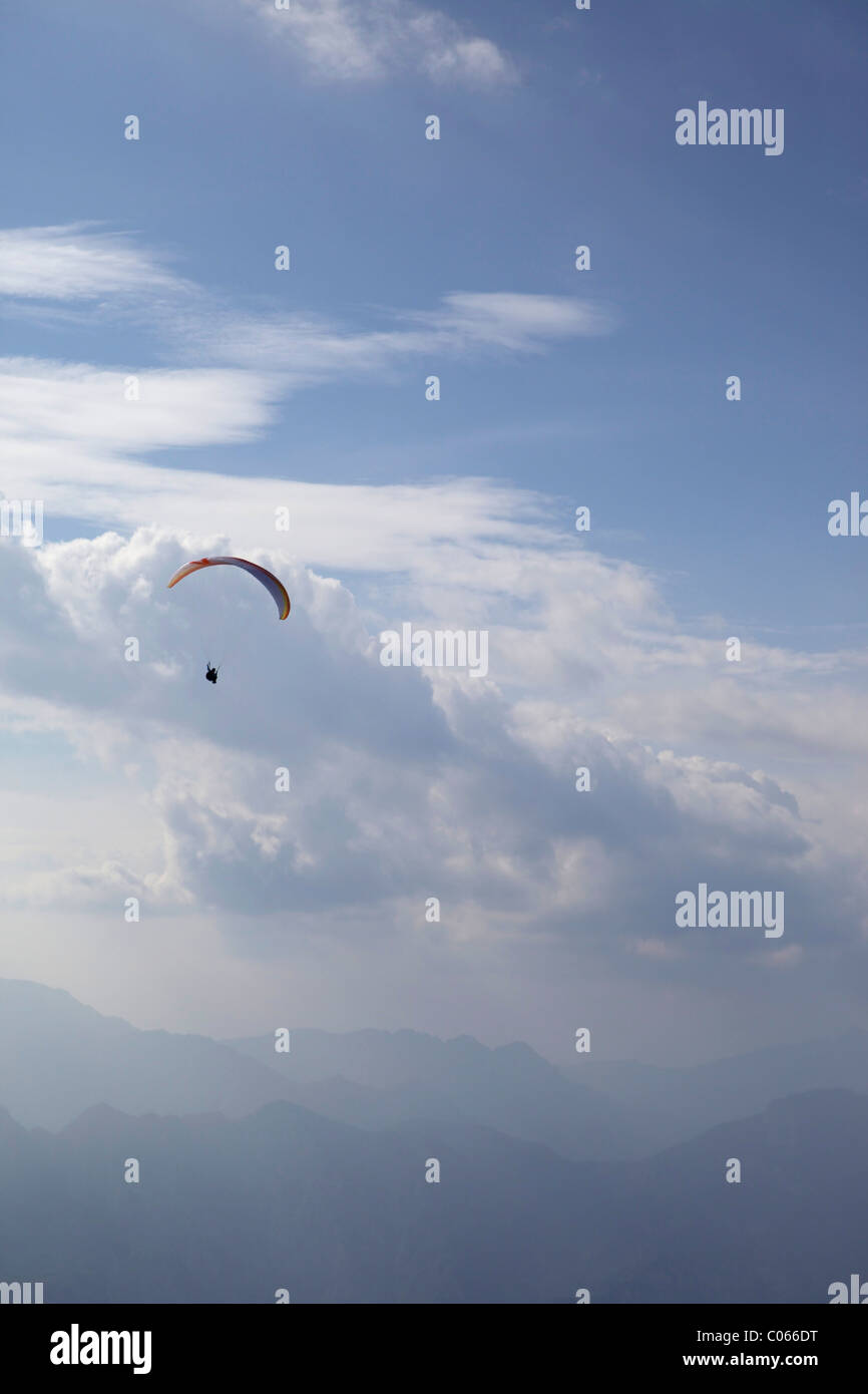Paragliders taking part in extreme sports, jumping and flying from Monte Baldo mountain range near Lake Garda in Italy. Stock Photo