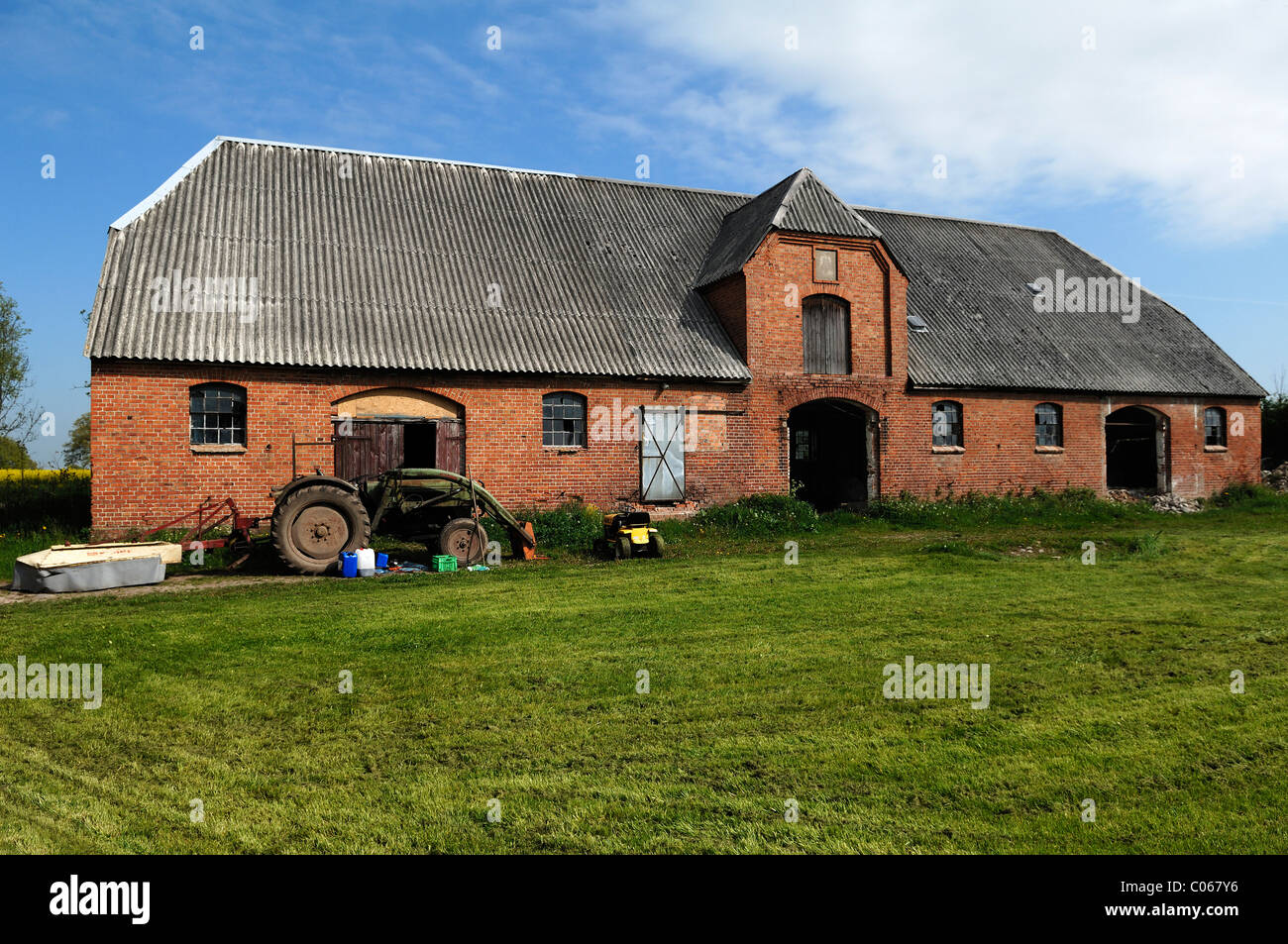 Old tractor in front of a former horse stable, 1923, Gut Othenstorf, Zum Weissen Haus 1, Othenstorf, Stock Photo