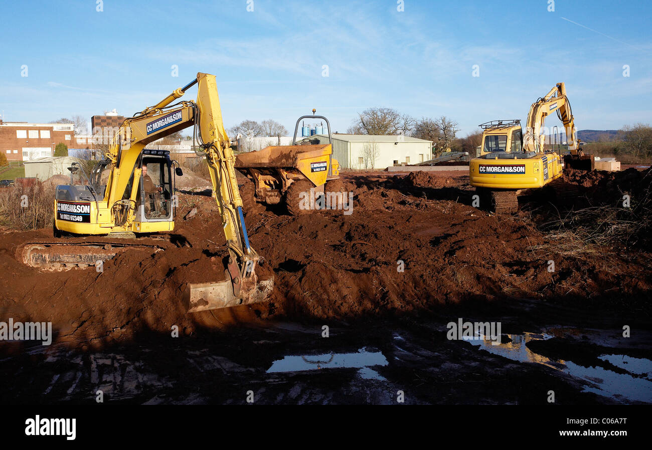 Mechanical diggers excavating earth on a building site Stock Photo Alamy