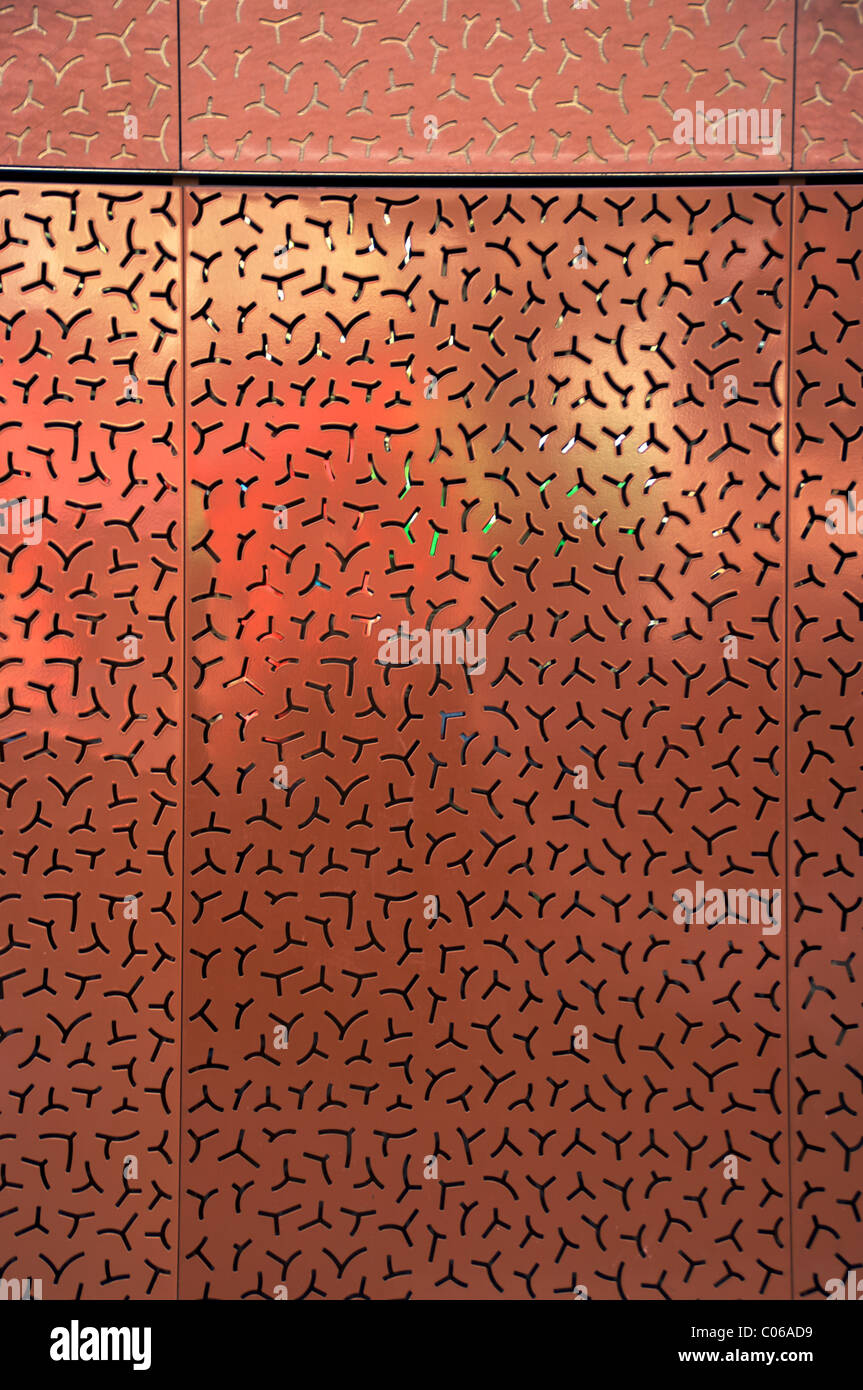 Copper metal punched wall with reflections. Stock Photo