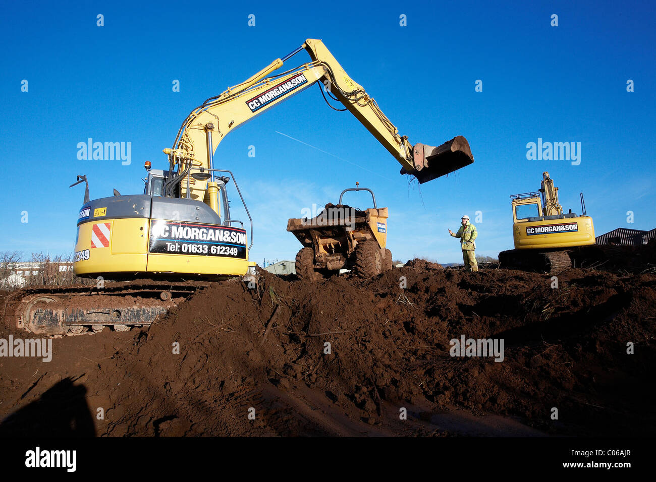 Mechanical Diggers Excavating Earth On A Building Site Stock Photo - Alamy